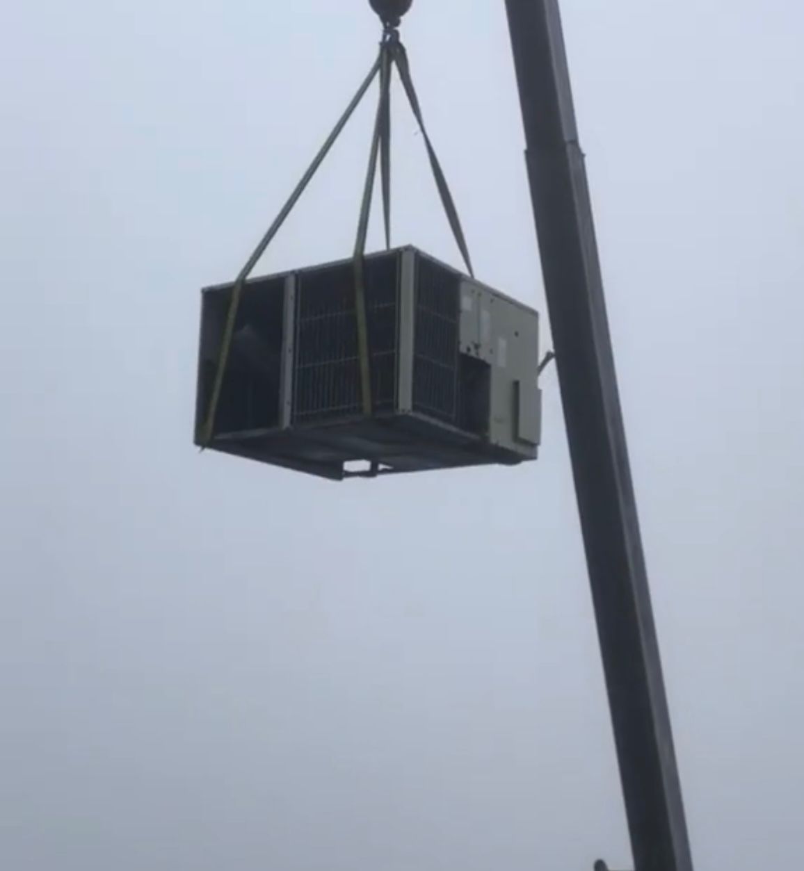 Commercial rooftop HVAC unit being removed by crane during a replacement job in Scarborough