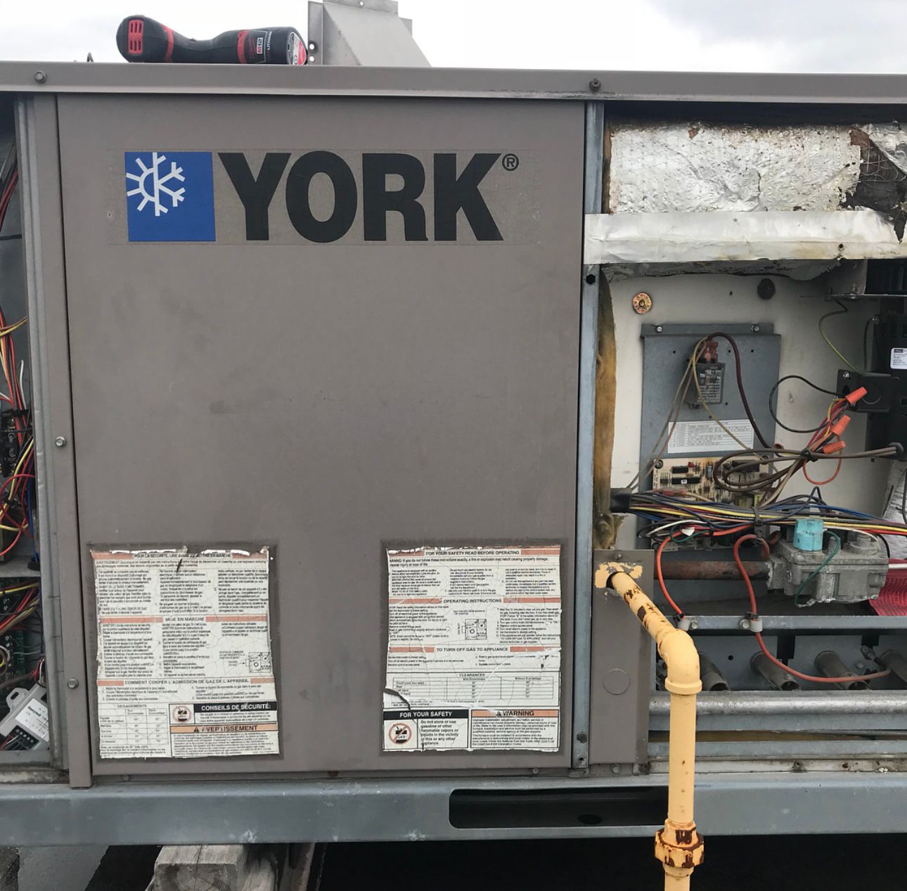 York rooftop unit with access panel open during maintenance service in North York