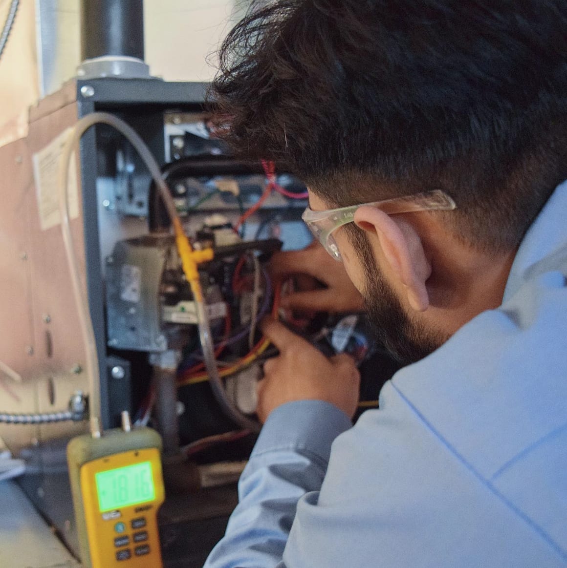 Complete Air Solutions technician servicing HVAC equipment